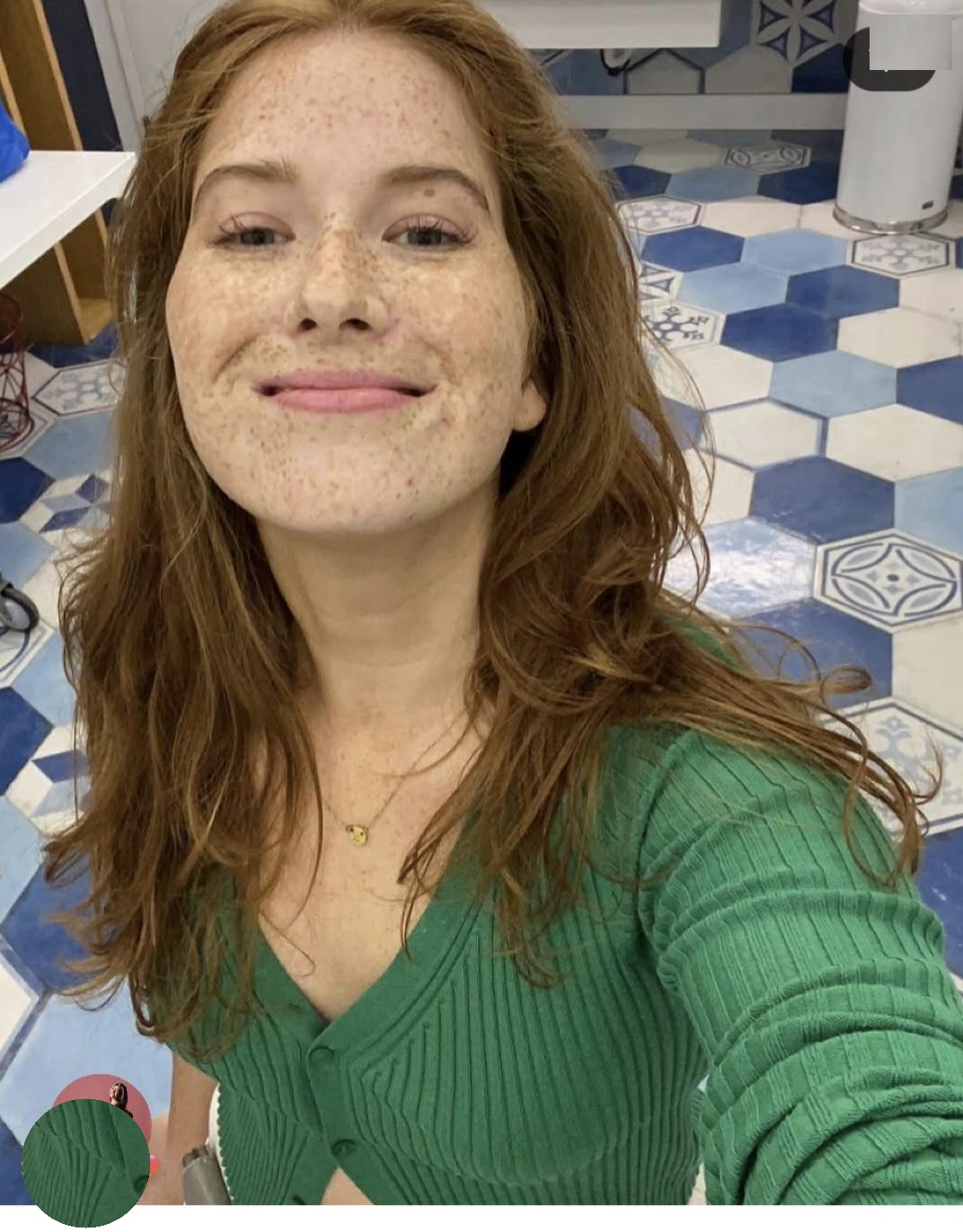 Close-up of Kate Broderick in a green sweater.