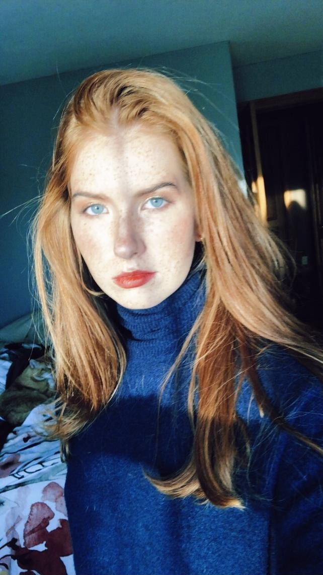 Kate Broderick in a blue turtleneck.